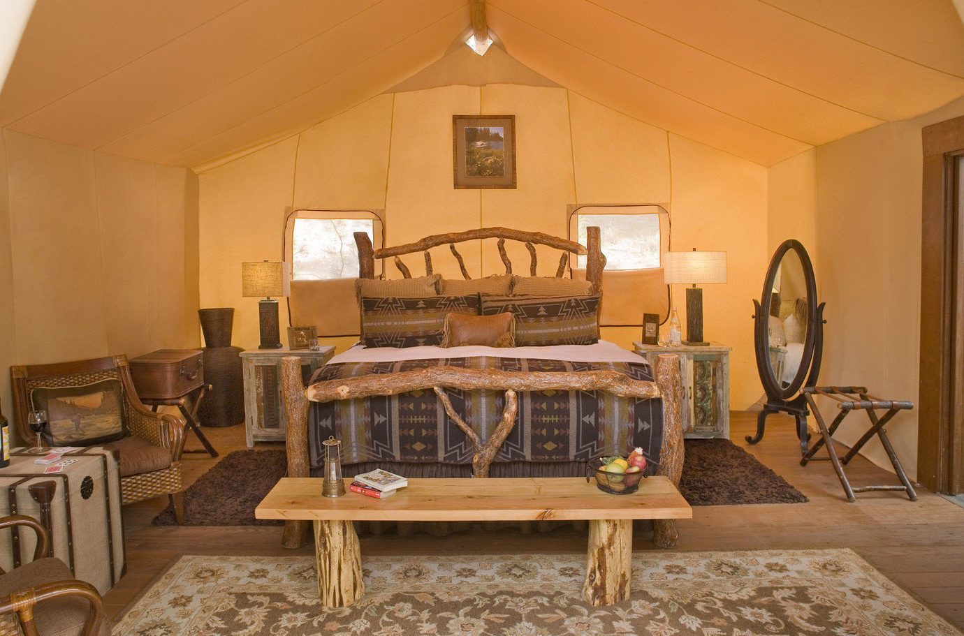 Bedroom Glamping Luxury Nature Outdoors Outdoors + Adventure remote Road Trips Rustic tent tents Trip Ideas Weekend Getaways wilderness wall indoor floor ceiling room property Living living room estate home furniture cottage interior design wooden dining room Villa farmhouse mansion wood real estate Suite area