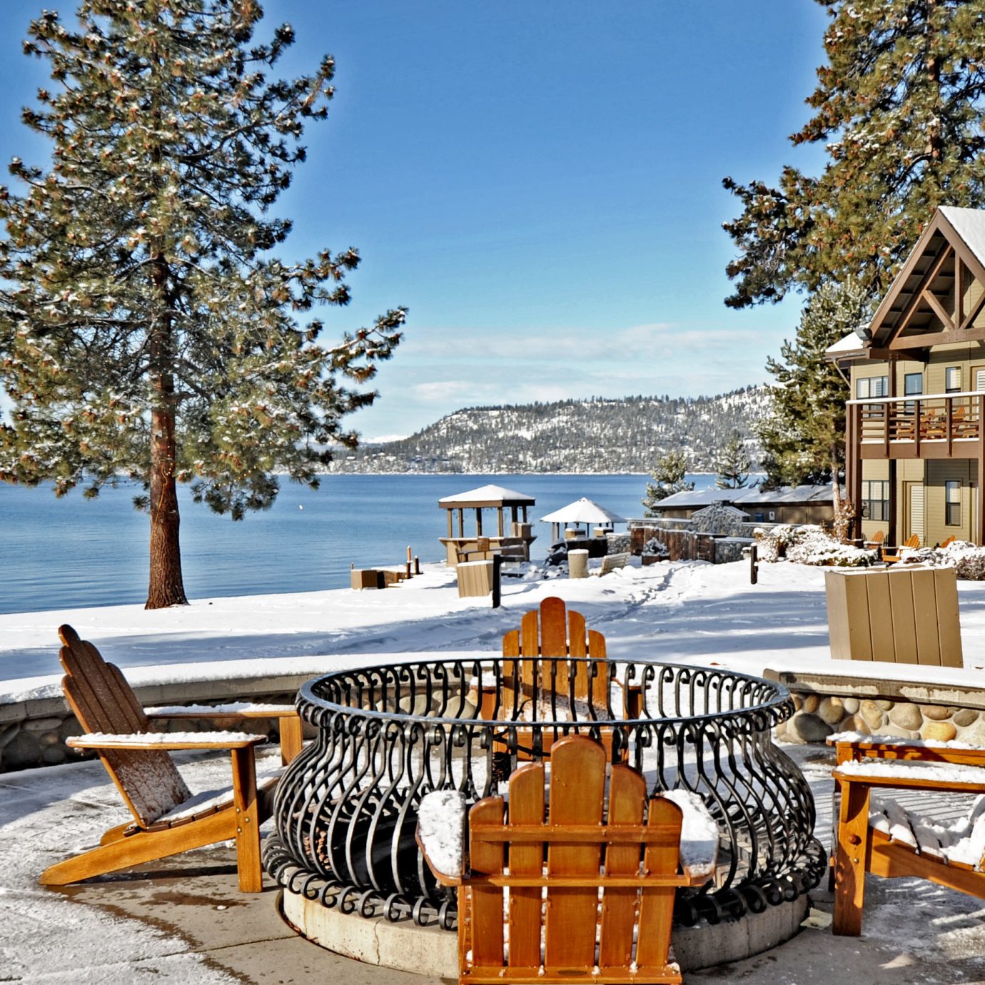 Firepit Lounge Mountains Natural wonders Nature Outdoor Activities Outdoors Scenic views Waterfront tree sky bench ground chair wooden Winter Picnic season Resort snow park home walkway Sea Lake vehicle dock log cabin overlooking Deck