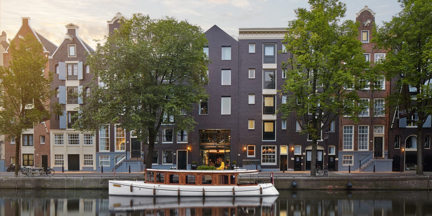 Amsterdam Boutique Hotels Hotels The Netherlands Trip Ideas outdoor sky water Canal City neighbourhood landmark Town urban area tower block waterway residential area reflection house cityscape human settlement Architecture Downtown River condominium facade town square skyline
