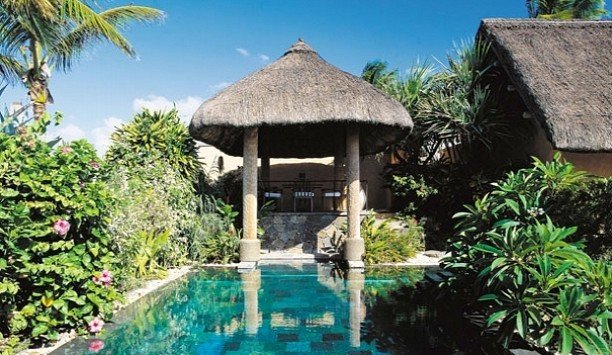 tree building property Resort house Villa cottage Garden hut outdoor structure hacienda swimming pool arecales eco hotel leisure palm tree thatching gazebo roof surrounded stone bushes