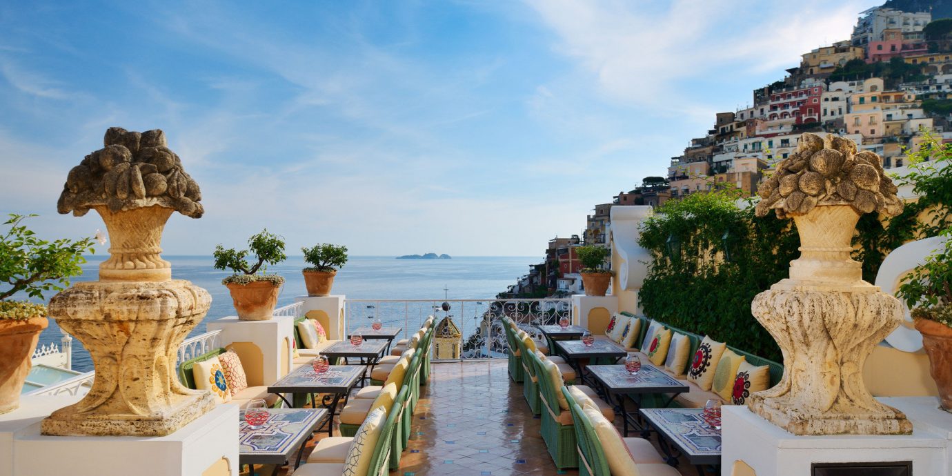 Buildings calm Cliffs Dining Elegant europe Hotels houses landscape Luxury Ocean ocean view outdoor dining overlook Patio regal remote serene sophisticated Terrace view sky outdoor vacation landmark tourism palace ancient history travel temple Resort Beach several