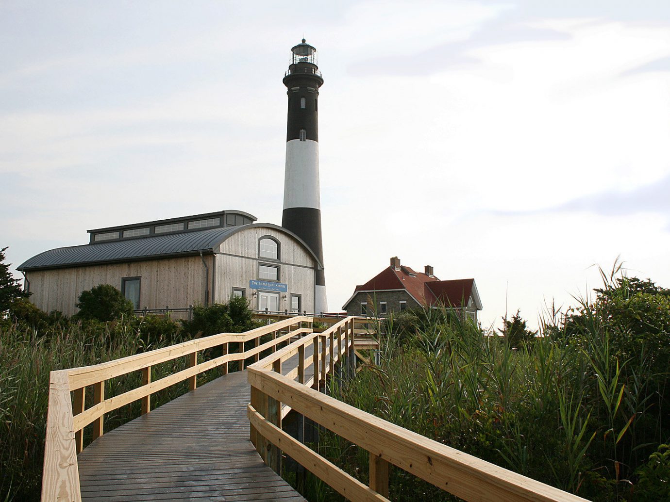 boardwalk Buildings Fog Greenery isolation lighthouse remote Scenic views Trip Ideas view outdoor sky tree building tower wooden waterway Coast walkway stone