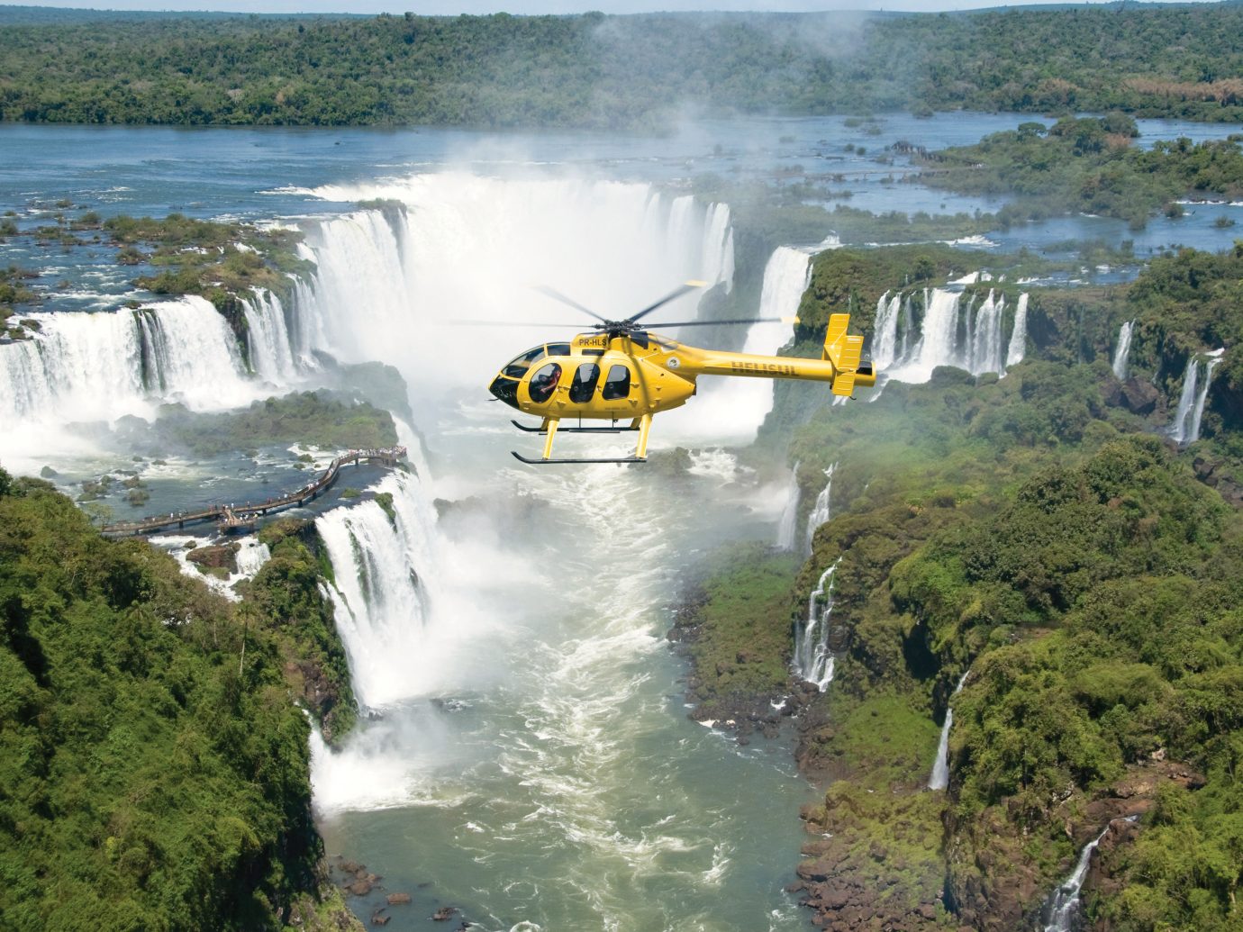 Helecopter Going Over Waterfall In Brazil By Belmond Hotel, Iguacu National Park