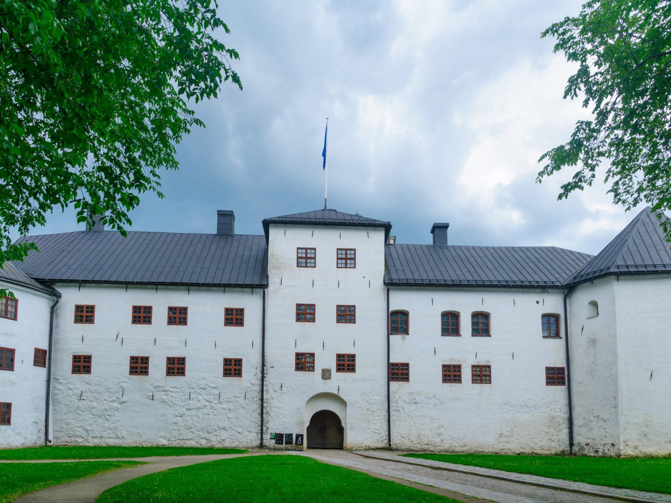 Finland Trip Ideas tree outdoor grass building sky house château estate property manor house facade stately home mansion castle medieval architecture national trust for places of historic interest or natural beauty palace window almshouse abbey residential roof old