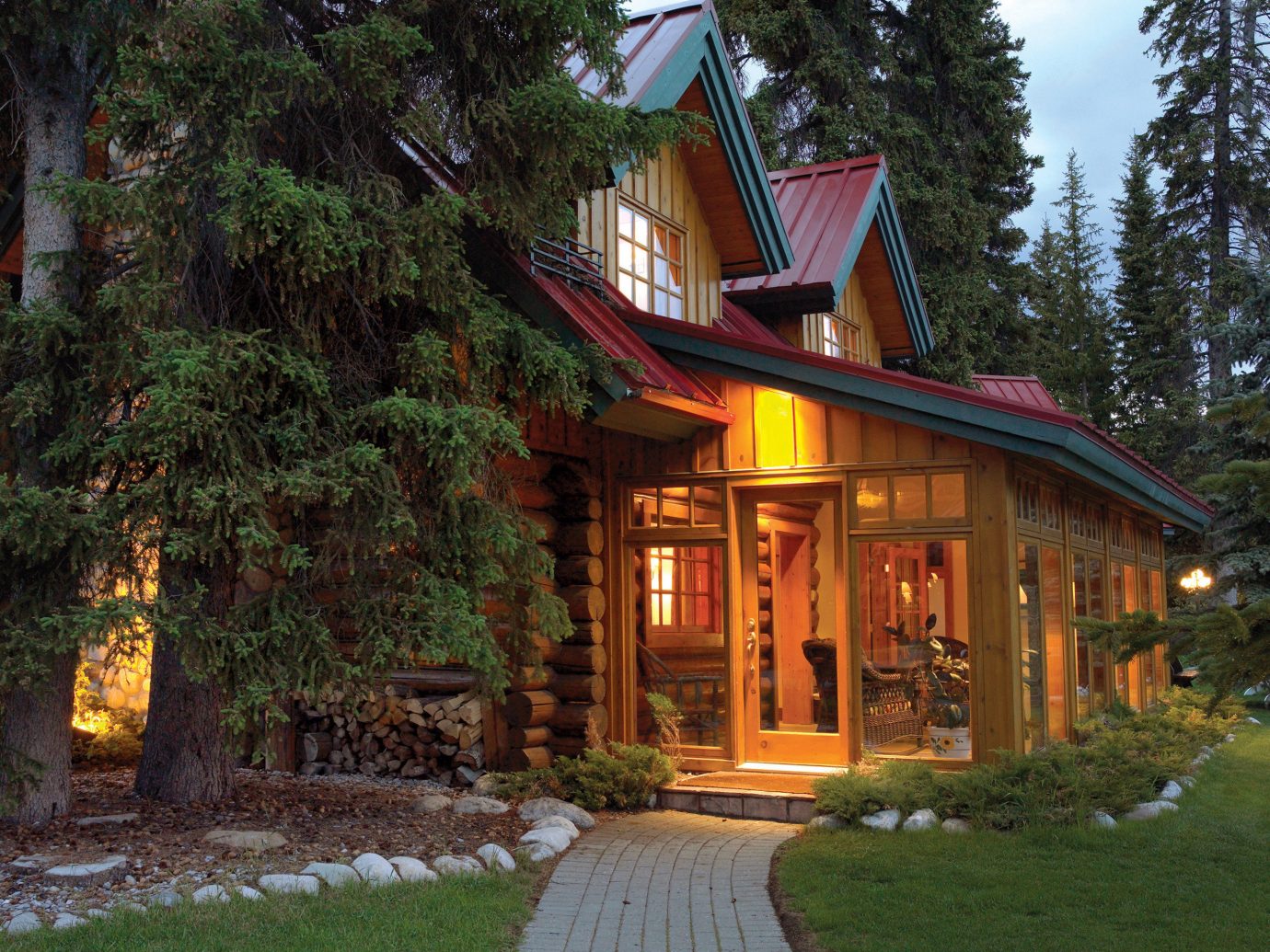 Alberta Architecture Boutique Hotels Canada Exterior Hotels Nature Rustic Scenic views home house cottage log cabin tree plant real estate lighting estate landscape outdoor structure facade evening building siding landscaping