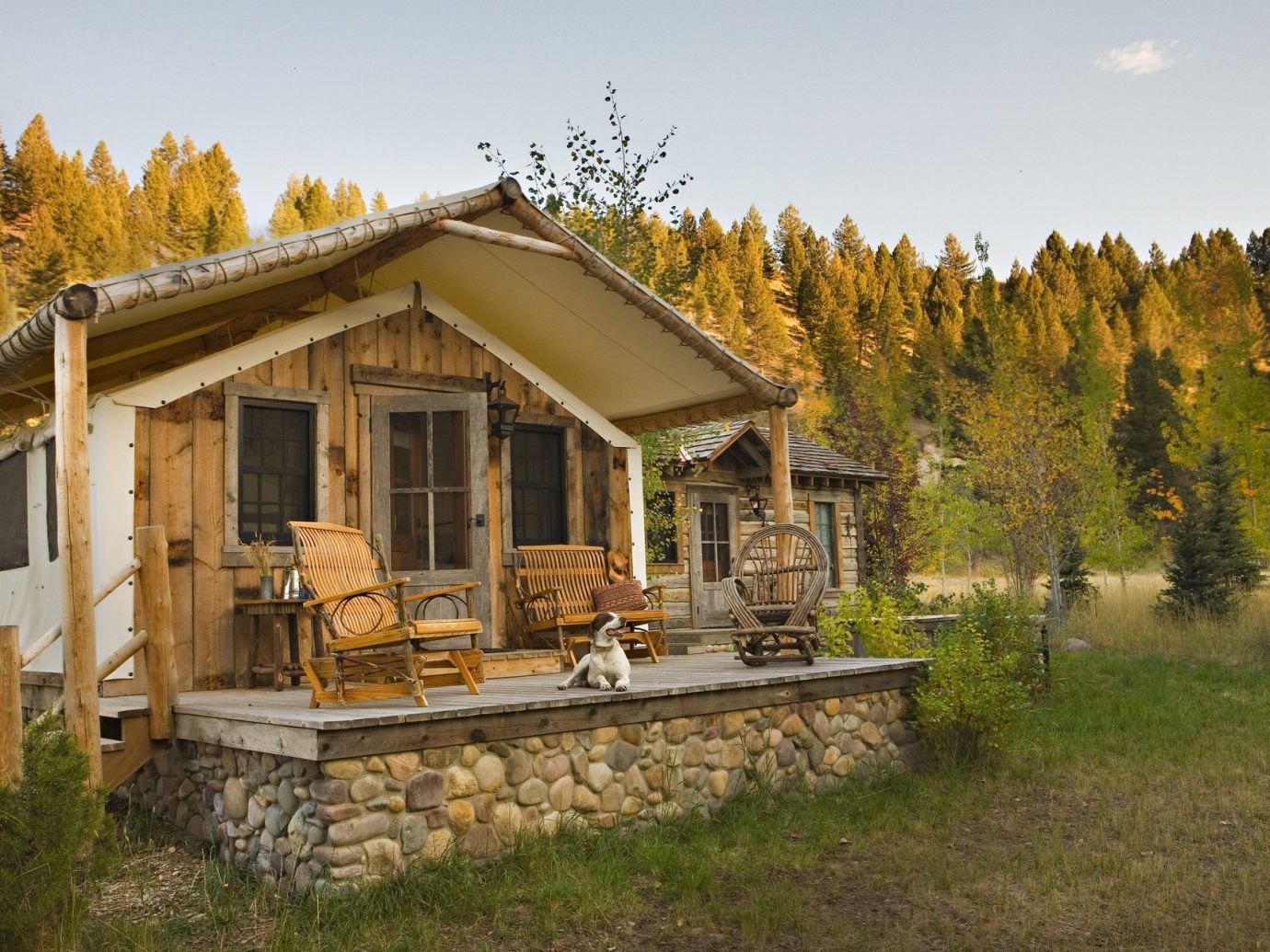 Glamping Hotels Luxury Travel Montana Outdoors + Adventure Trip Ideas Weekend Getaways outdoor grass sky tree building log cabin house property home estate cottage hut real estate old outdoor structure backyard farmhouse Villa shack