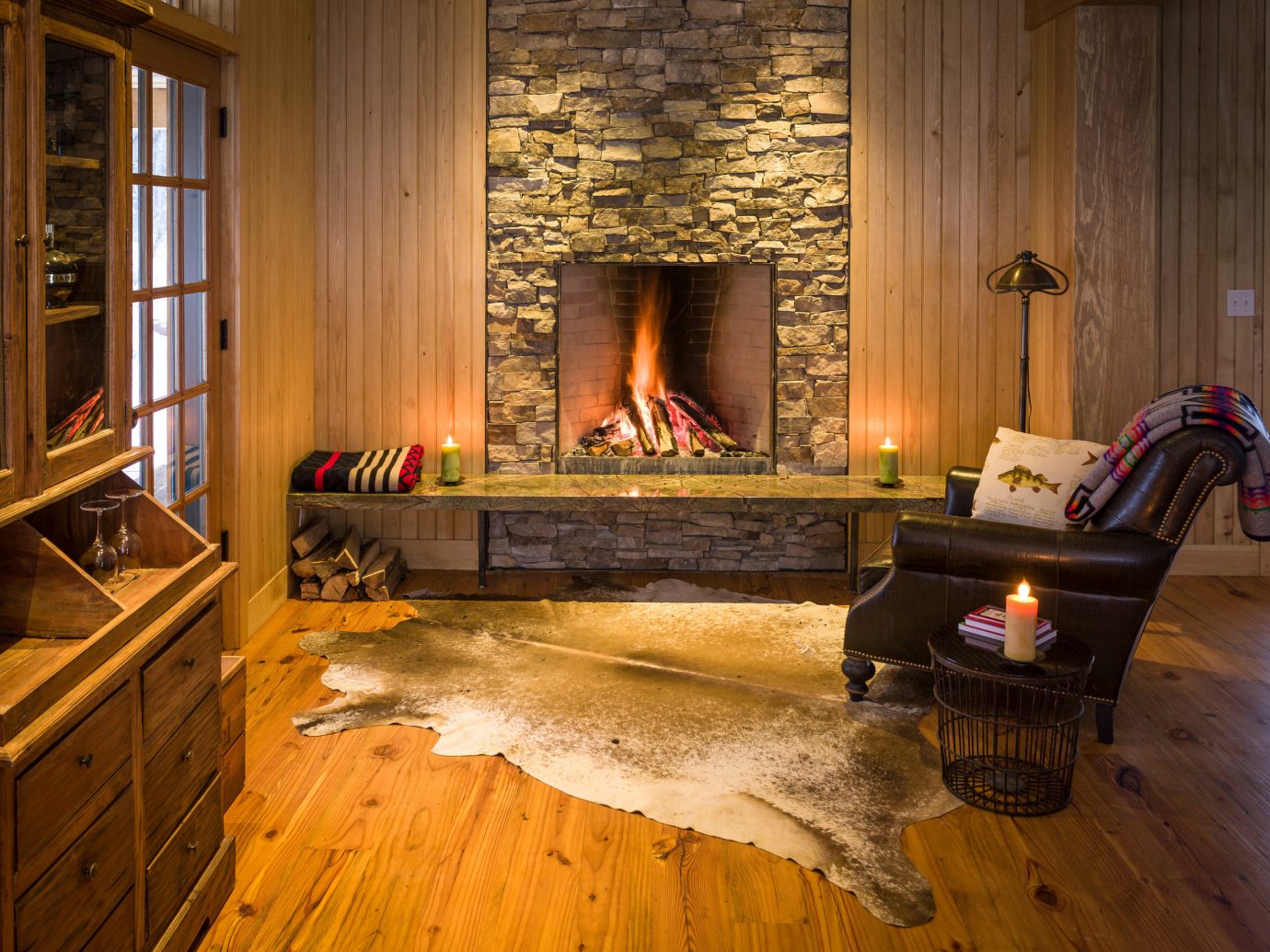 Adventure Country Forest Glamping Living Mountains Outdoors + Adventure Rustic Weekend Getaways Wellness indoor floor room building window property Fireplace home wood hearth hardwood living room house furniture estate cottage wooden wood flooring interior design farmhouse flooring hard
