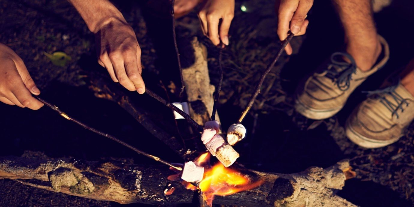 Outdoors + Adventure person cutting knife cut slice soil campfire chocolate