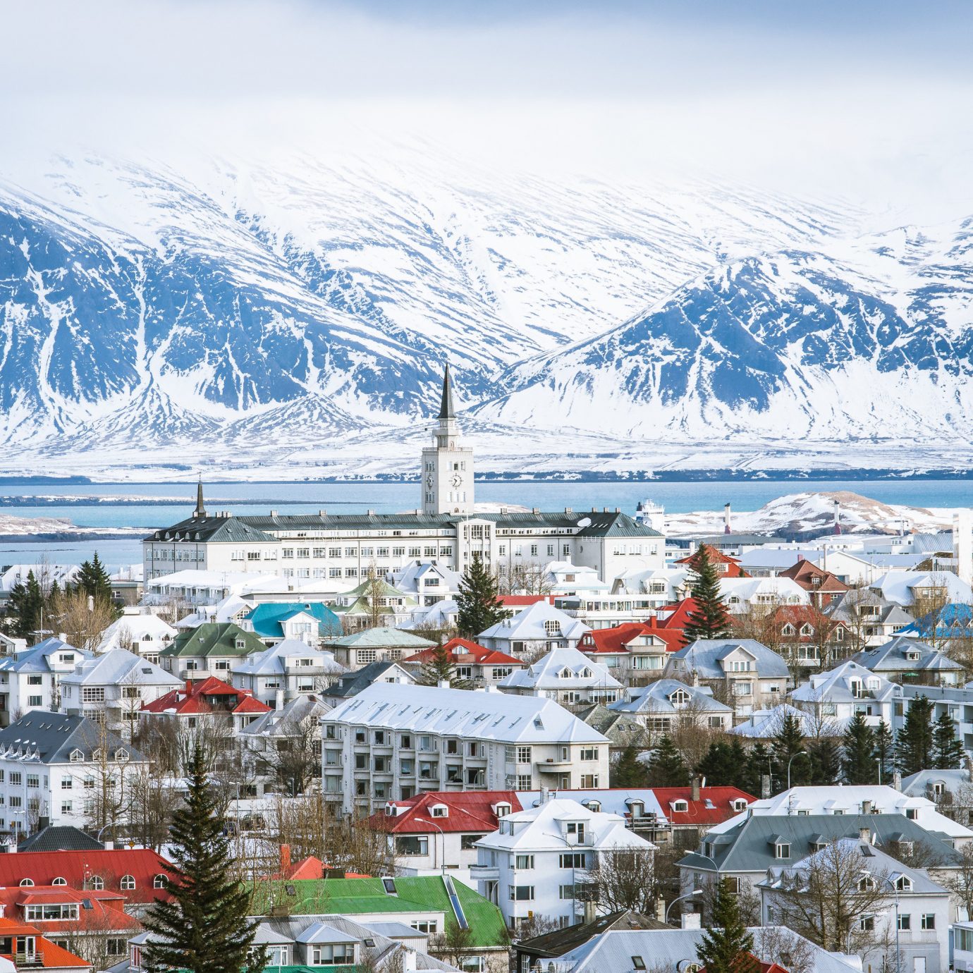 Boutique Hotels Hotels Iceland Reykjavík Winter snow mountain range Town mountain sky alps City glacial landform tourist attraction tourism arctic tree mountain village water mount scenery Village landscape Lake fell freezing house