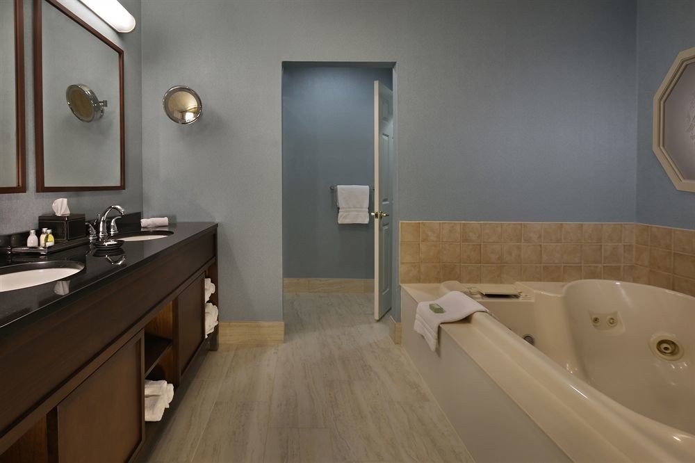 bathroom sink property mirror vessel bathtub flooring Suite plumbing fixture tan