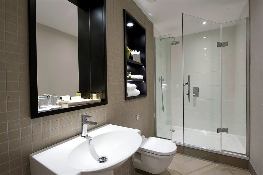 bathroom mirror property sink toilet home bidet Suite tiled tan