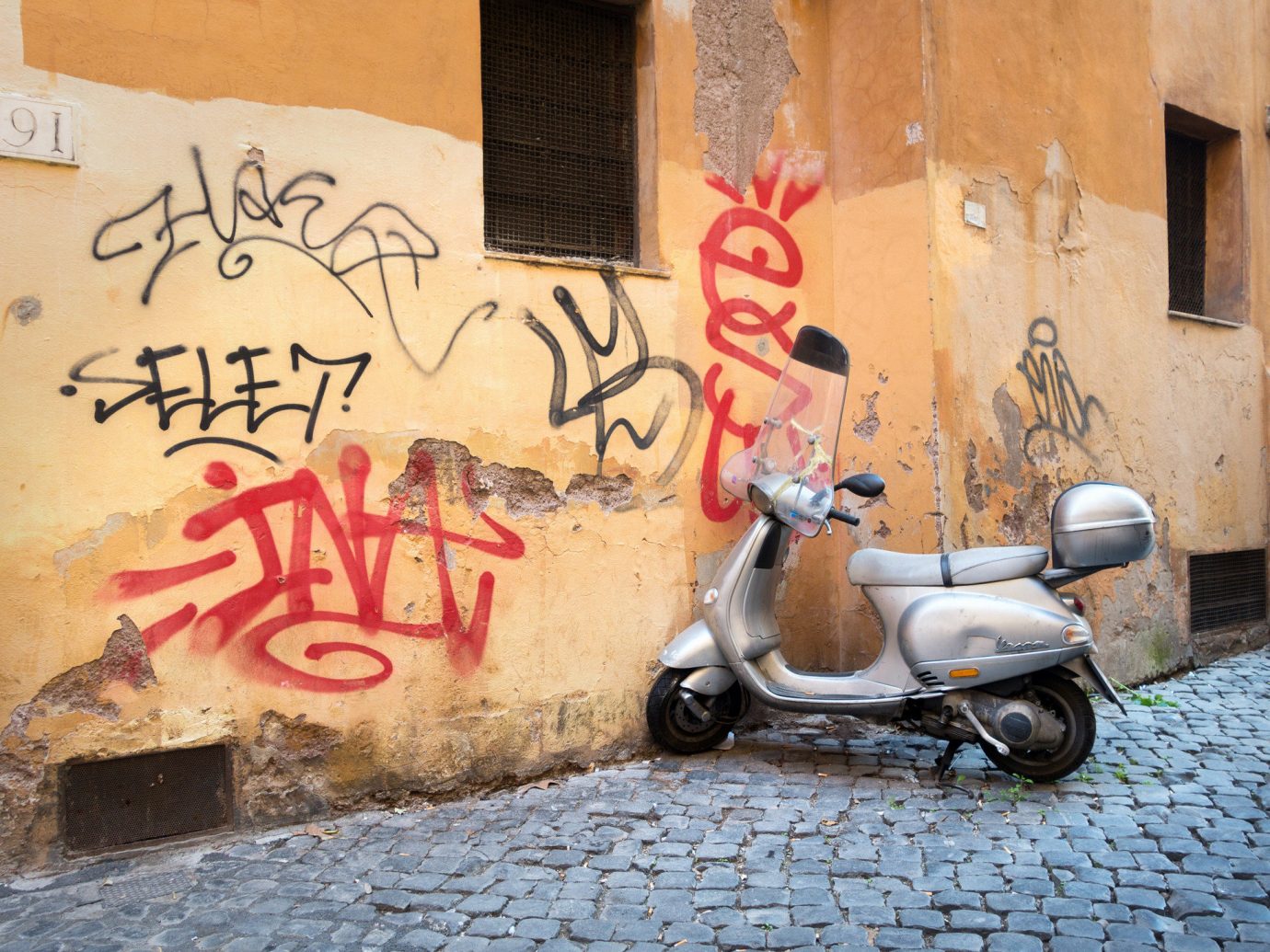 Travel Tips building outdoor graffiti art wall street art parked abstract street vehicle mural road painted scooter