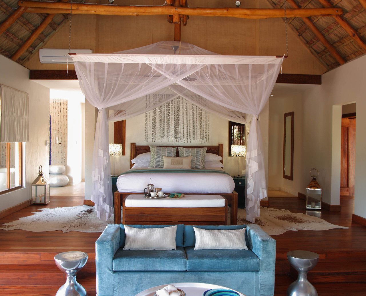 bed Bedroom canopy canopy bed charming cozy homey Hotels hut Luxury Rustic indoor floor room ceiling property house estate swimming pool Living home living room interior design cottage Villa mansion Design Resort farmhouse furniture