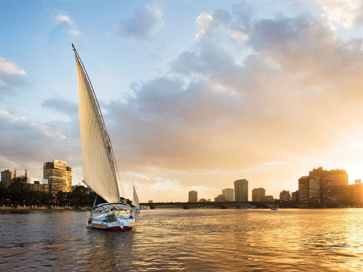Lakes + Rivers Landmarks sky water outdoor Boat sailboat reflection horizon vehicle sail Sea morning cityscape River evening skyline dusk sailing vessel skyscraper sunlight Sunset waterway sailing day distance