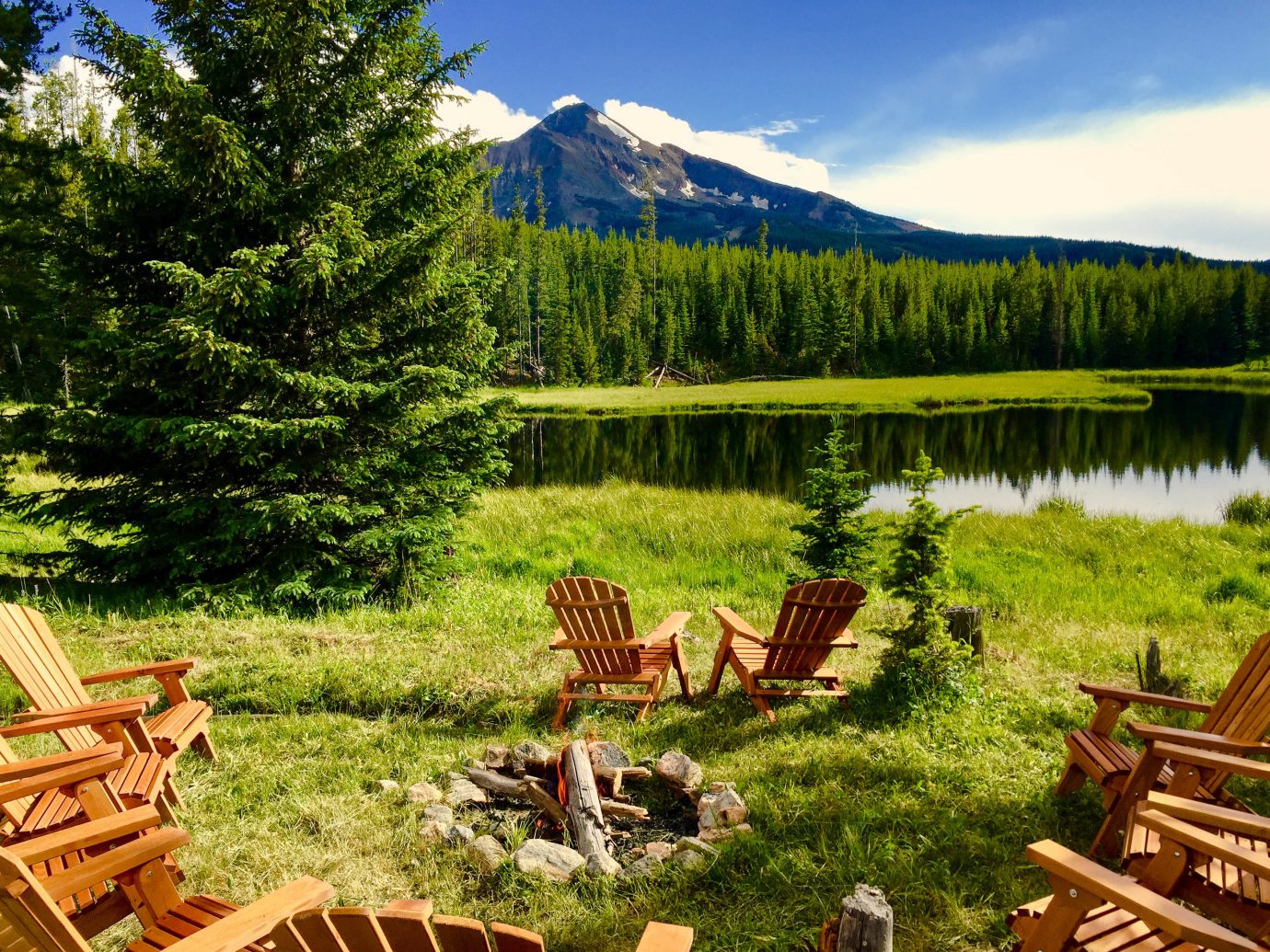 Glamping Hotels Montana Outdoors + Adventure Trip Ideas Nature wilderness nature reserve ecosystem national park mountain Lake mount scenery biome landscape tree meadow grass mountain range log cabin