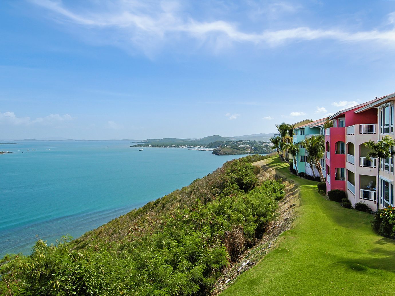 Hotels sky grass outdoor water Coast Sea landform geographical feature body of water shore Town vacation Beach Ocean bay Nature green tourism waterway cove cliff terrain Island cape grassy traveling lush hillside