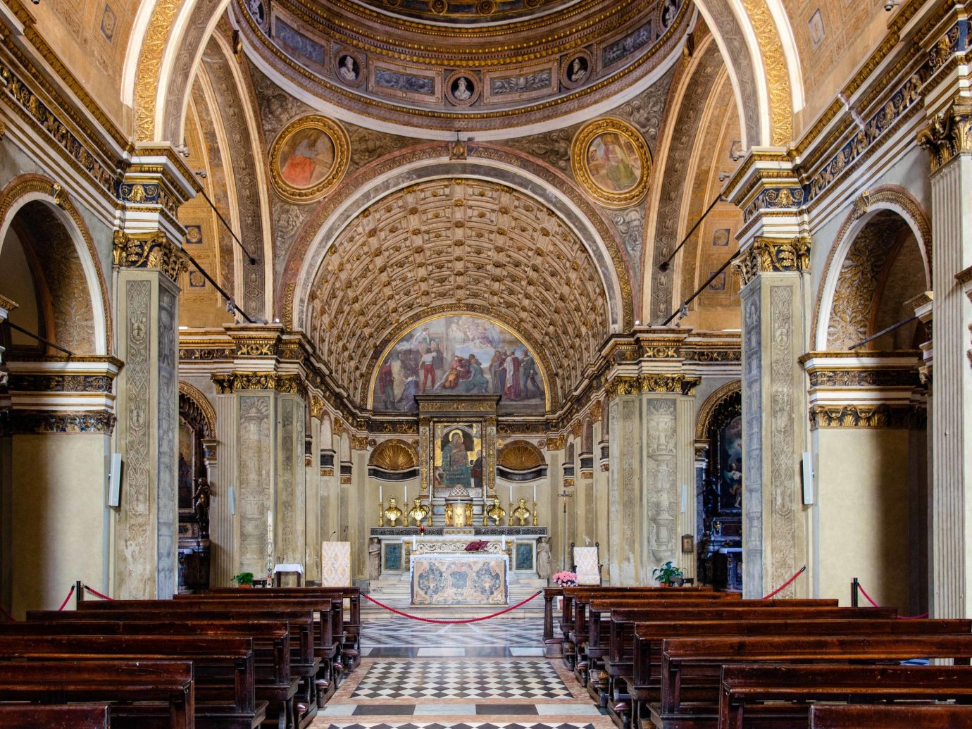 Arts + Culture Italy Milan place of worship indoor building religious institute Church chapel cathedral basilica byzantine architecture historic site column medieval architecture arch symmetry classical architecture abbey aisle worship wooden altar religion interior design synagogue window stone