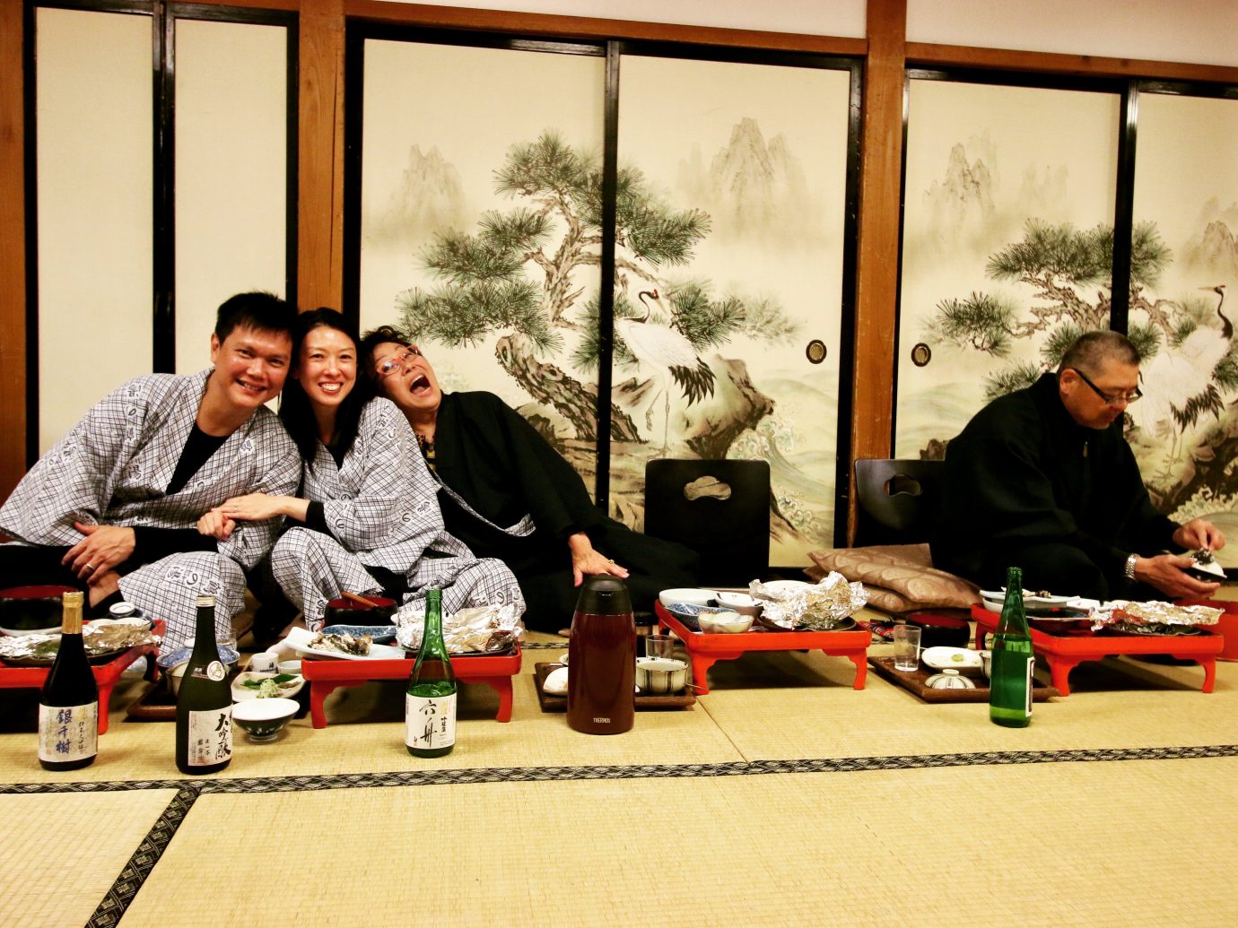 people eating dinner and drinking sake in japan