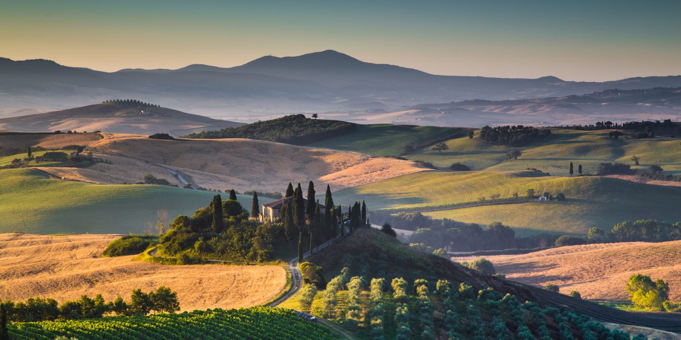 Scenic Tuscany landscape with rolling hills and valleys in golden morning light, Val d'Orcia, Italy.
