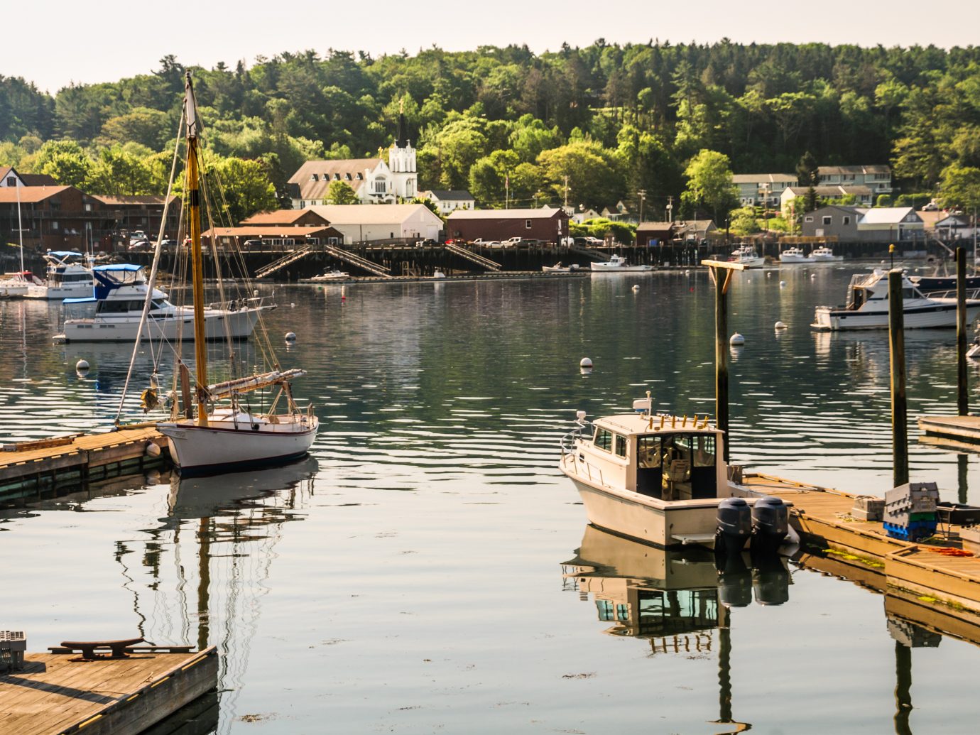 Morning light illuminates the boats in the waters of Boothbay Harbor, Maine in mid June.