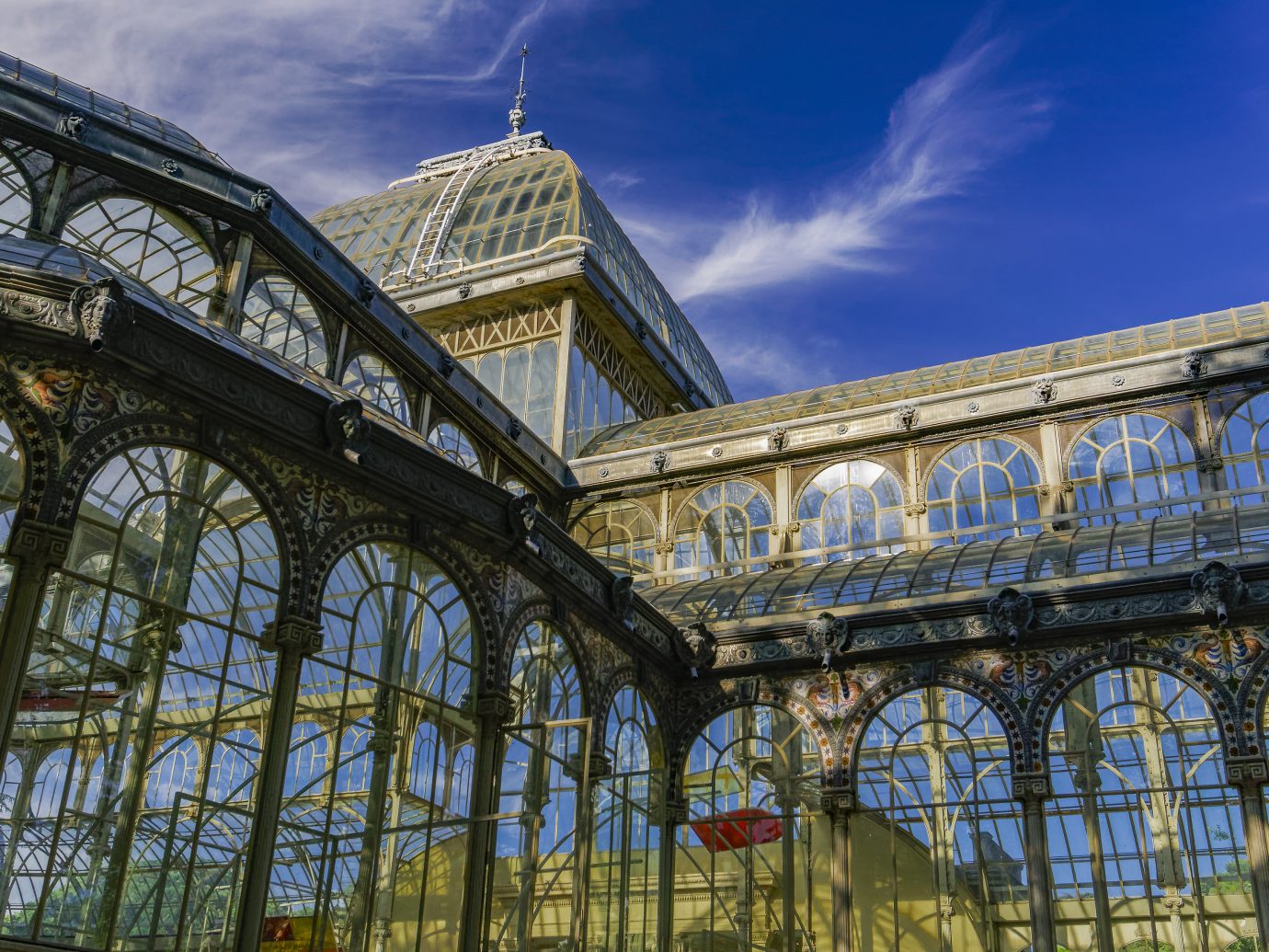 Day view of 1887 glass and metal structure of crystal palace at Park Retiro.