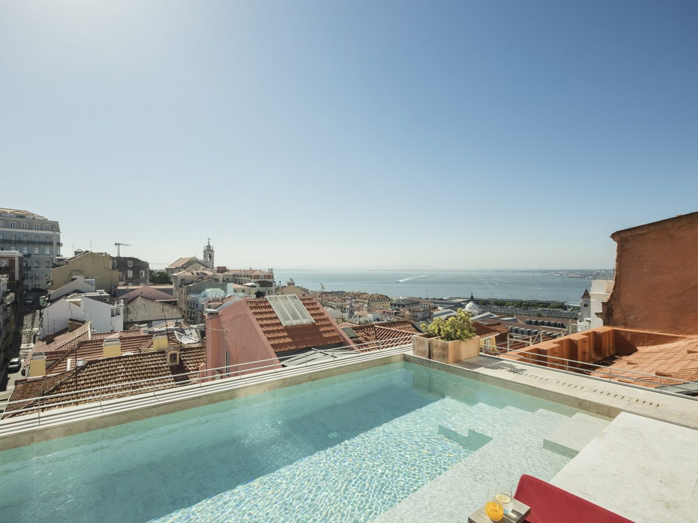 Rooftop swimming pool looking over Lisbon at Verride Palácio Santa Catarina
