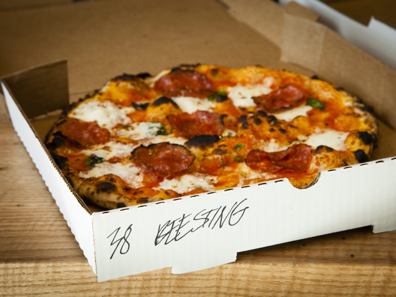 Roberta's Take-Out and Delivery Space, Brooklyn, NY; Beesting pizza in a to-go box. (Photograph by Deidre Schoo)