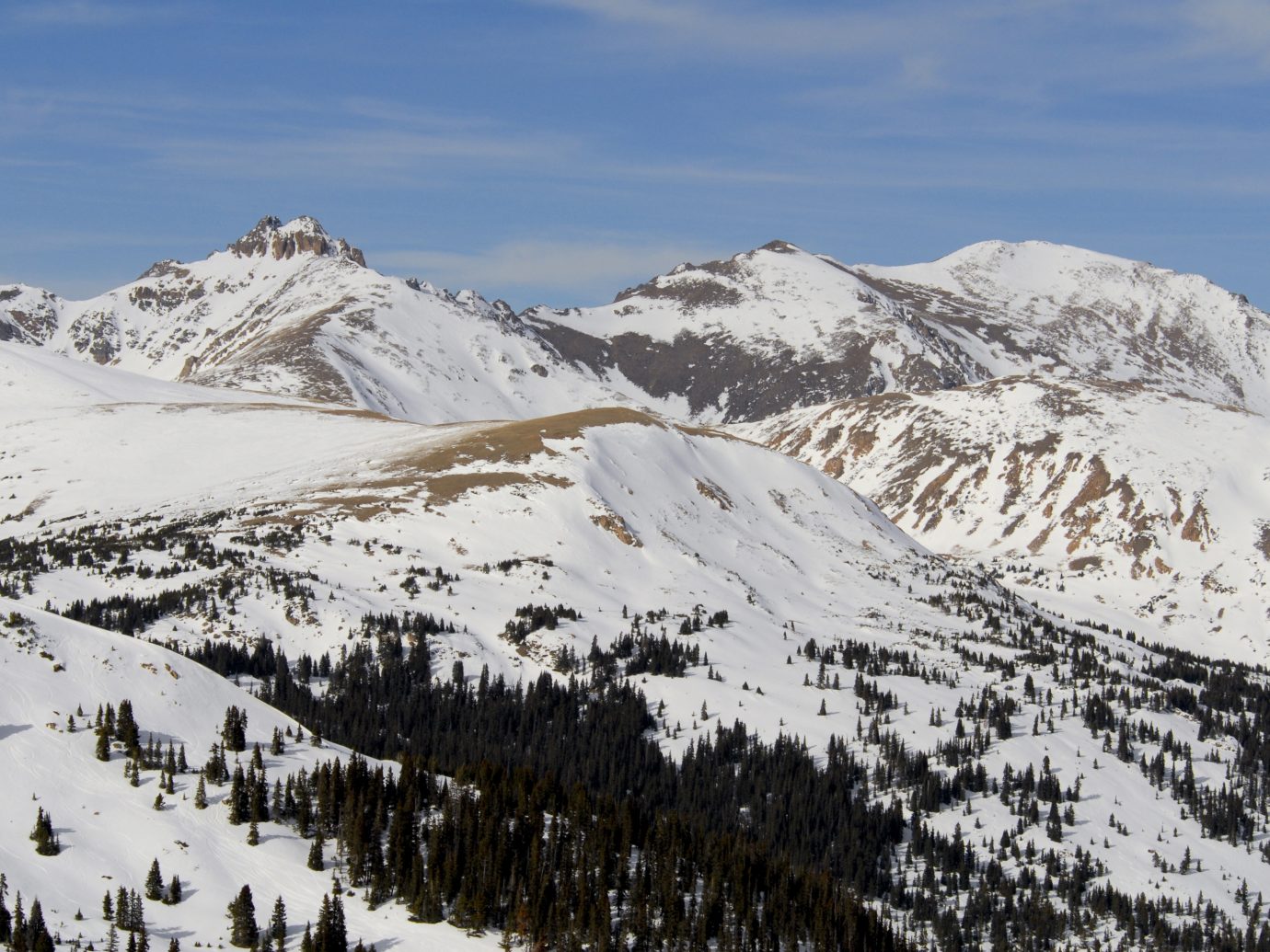 Rocky Mountain peaks in Colorado, covered in early season snow.