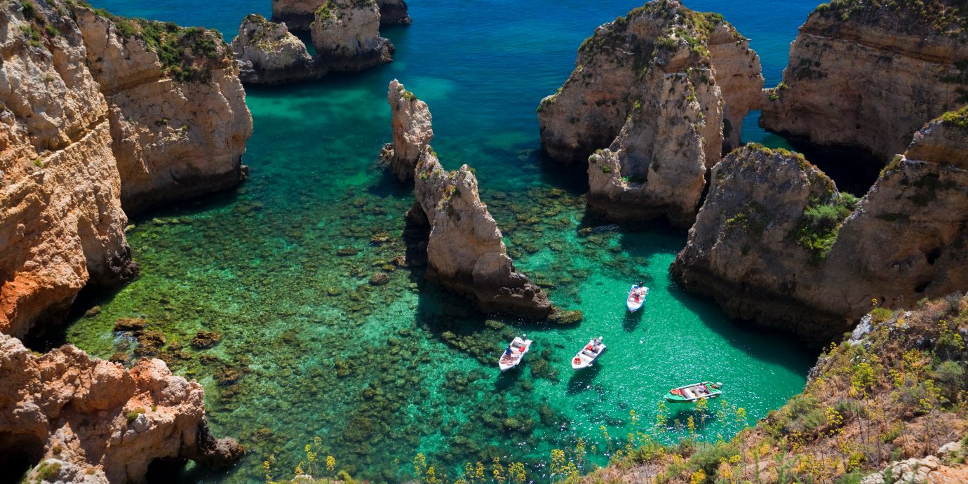 The best places to treavel in October, view of blue green waters in the Algarve, Portugal