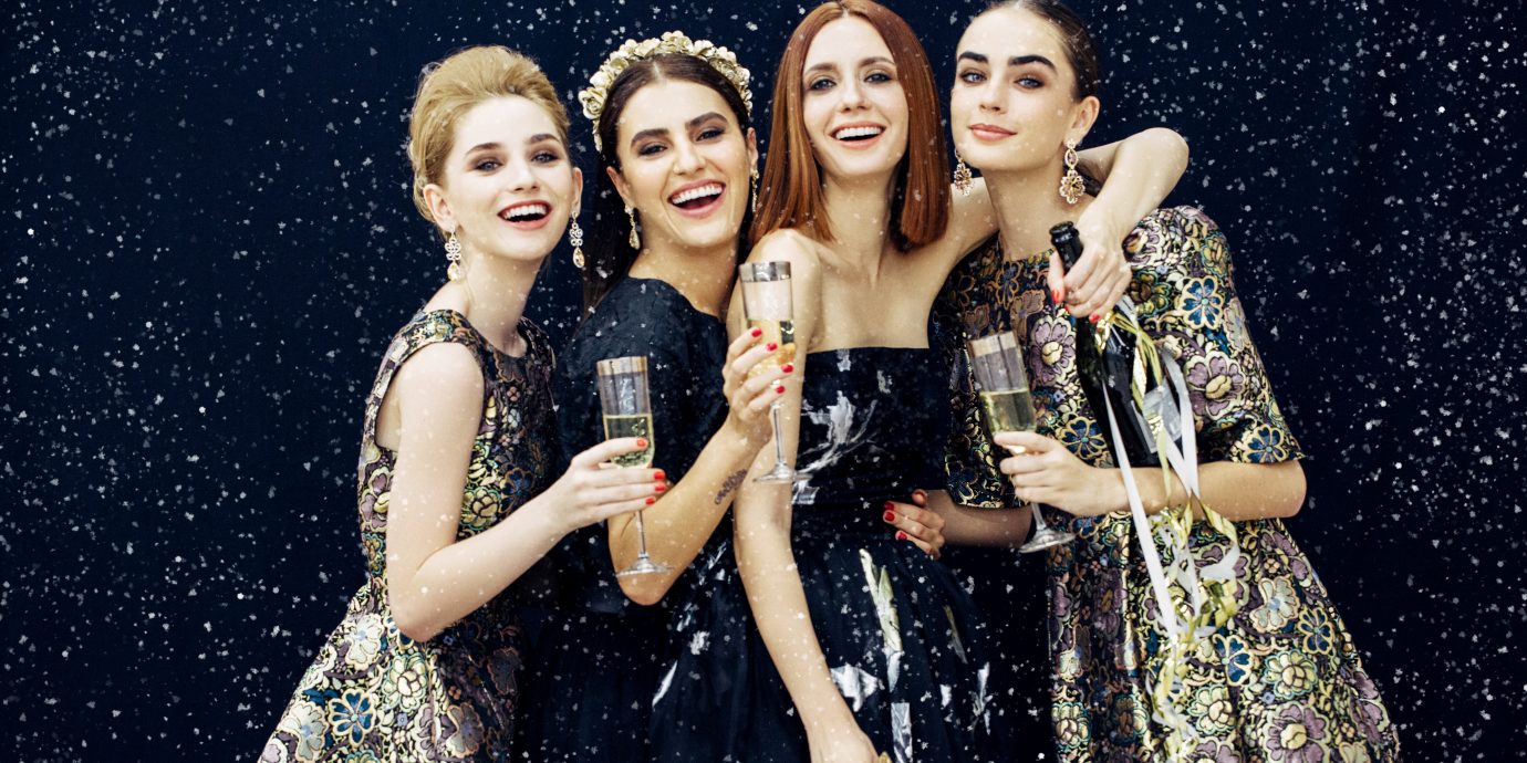 Stylish women at a holiday party with champagne