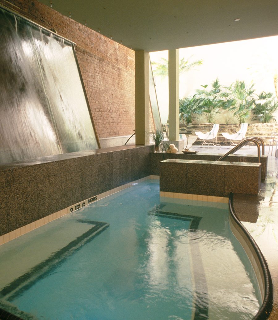 Indoor pool with waterfall decoration at Great Jones spa
