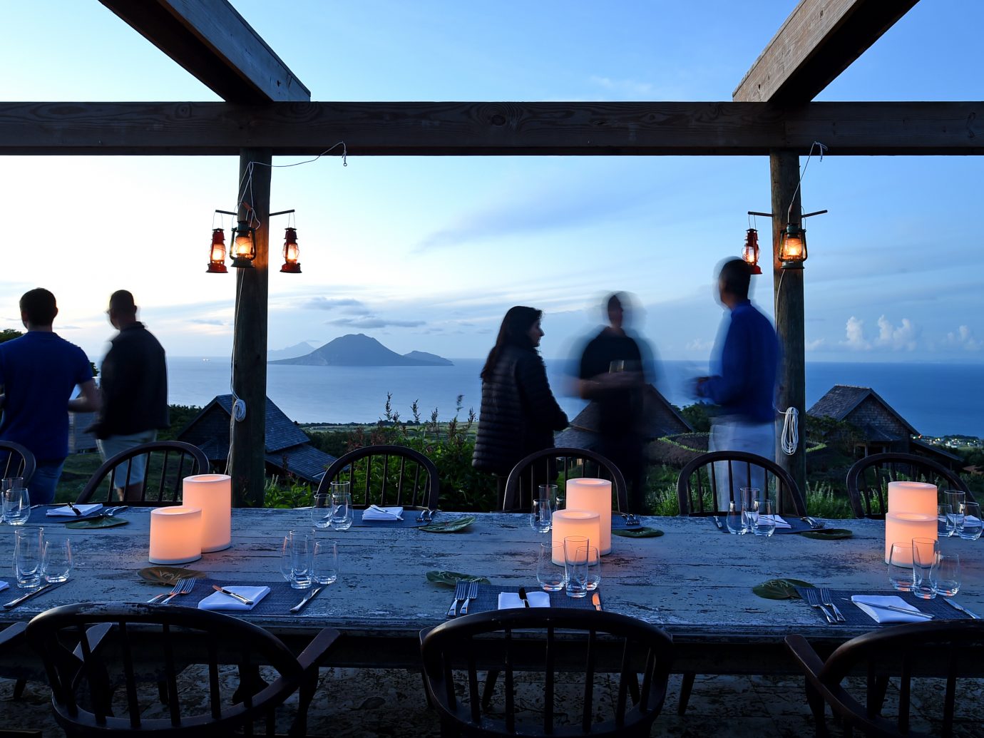 Farm to table experience with people socializing at dusk with a beautiful background