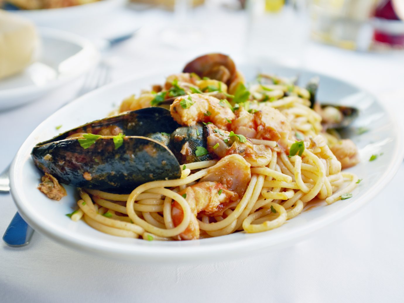 Fresh Seafood pasta - Spaghetti, clams, shrimps and squid, served in a restaurant in Italy.