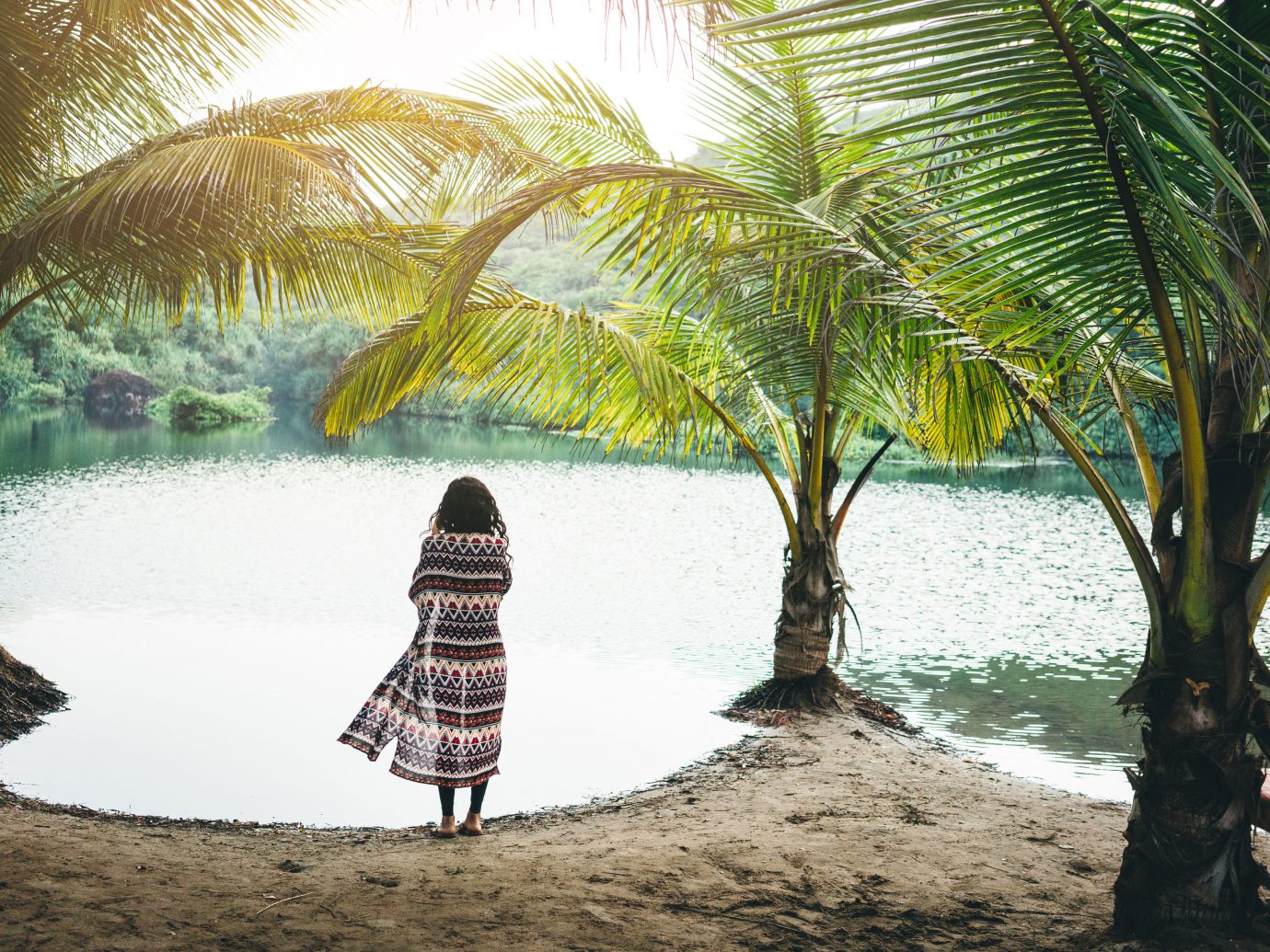 Woman on the shore of a tropical lagoon in Goa, India