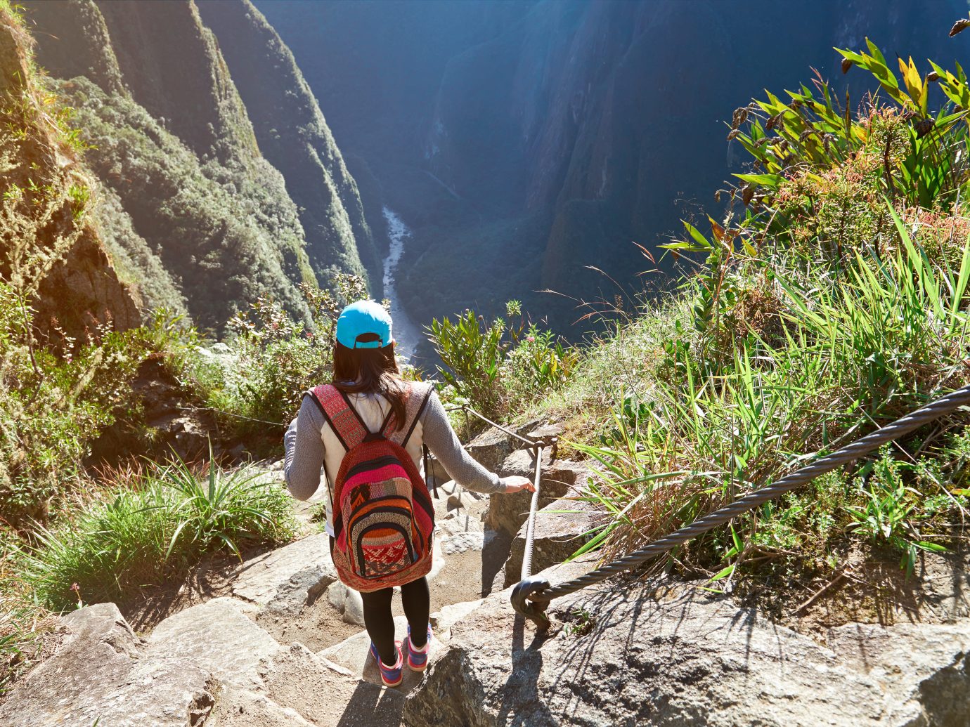 Woman in nature adventure walk in mountain landscape. Girl doing trekking in Machu Picchu path