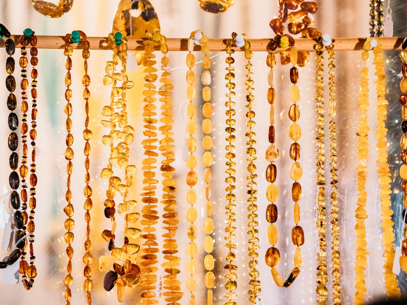 Variety Of Beads Made Of Amber. Jewellery Made Of Amber. Traditional Souvenirs At European Market. Souvenir From Baltic Countries, Europe.