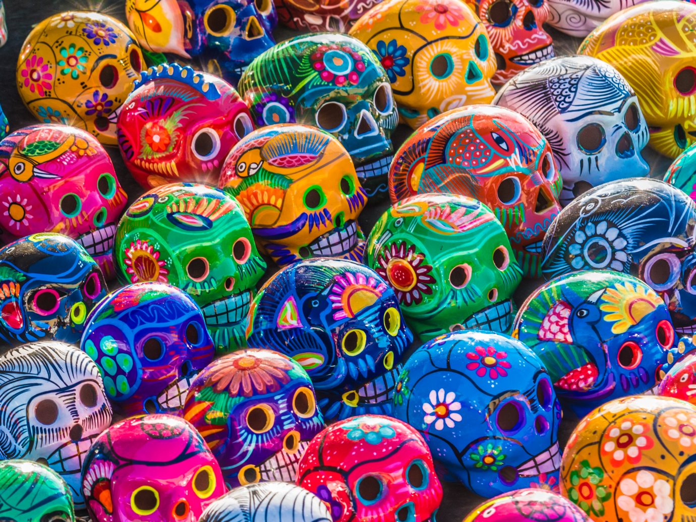 Mexican Culture Fiesta: Colorful (colourful) traditional Mexican/hispanic ceramic pottery Day of the Dead (Dia de los Muertos) skulls on display at a market in Mexico.