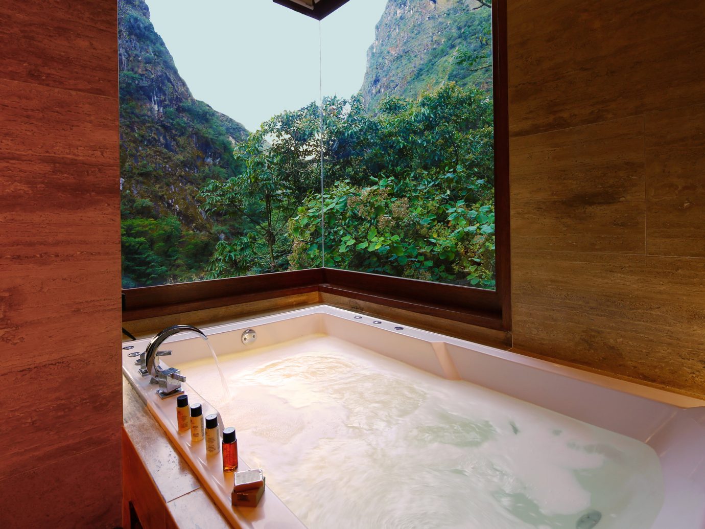 Luxurious bathtub in the imperial suite at SUMAQ overlooking lush Peruvian mountains