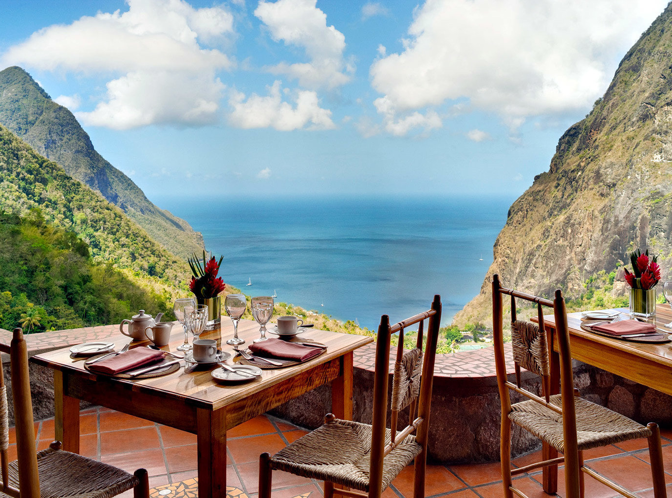 Outdoor seating overlooking beautiful blue water and pointy mountains at Ladera Resort