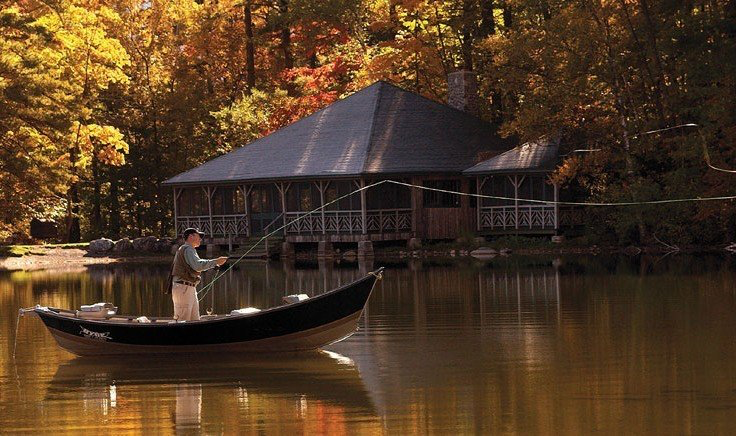 Man fishing on boat in autumn at Equinox Golf Resort & Spa