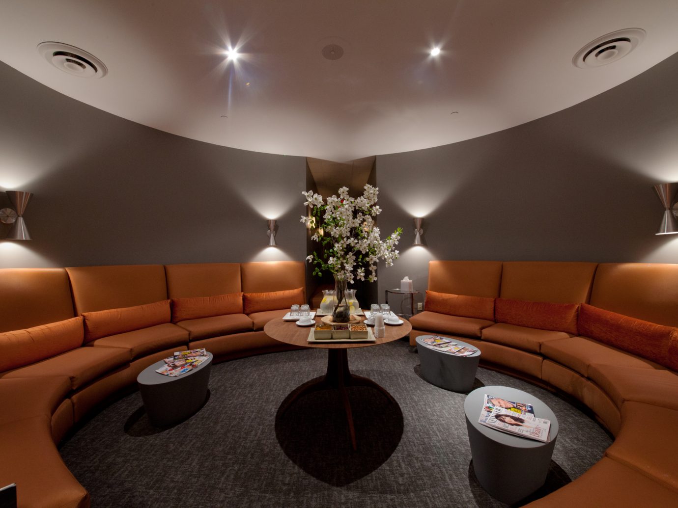 Round orange booth at the waiting room at Oasis Day Spa in NYC