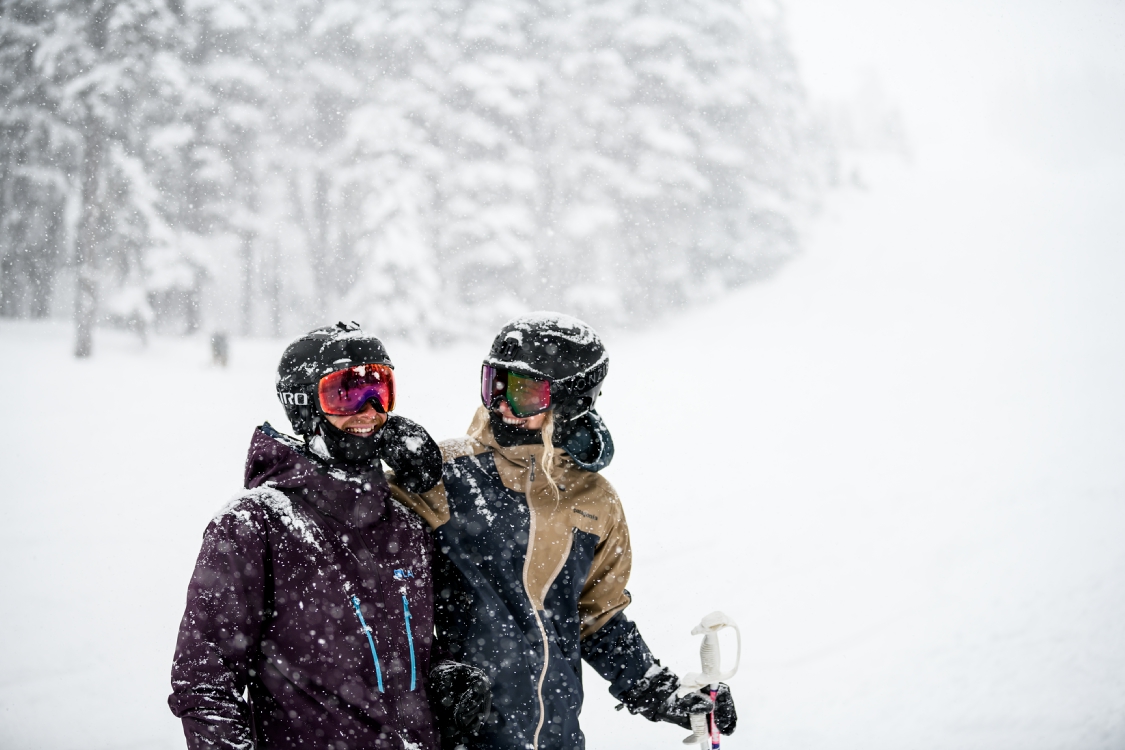 A couple enjoying the falling snow on Blackcomb Mountain