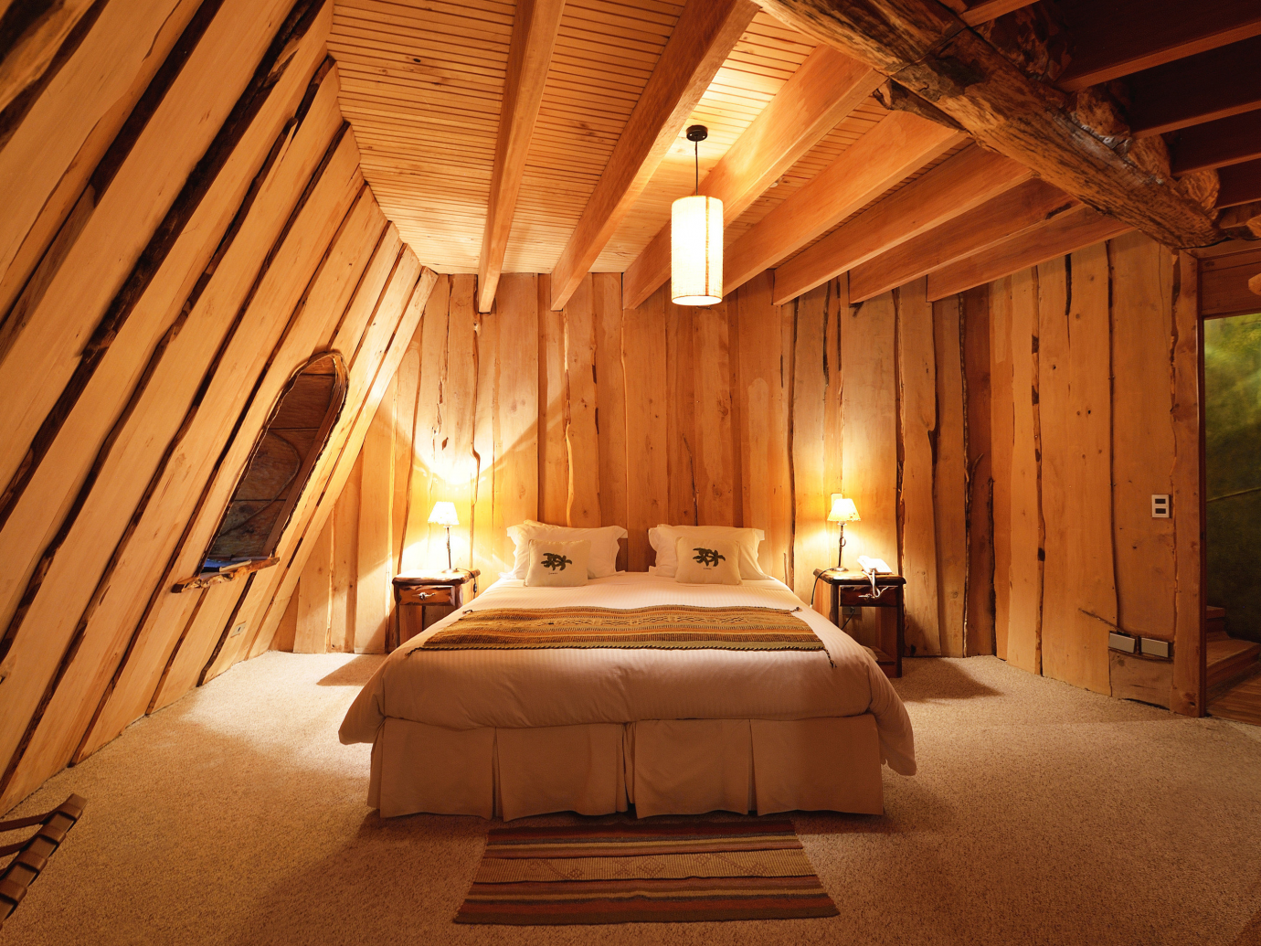 Wooden and warm room interior with queen sized bed