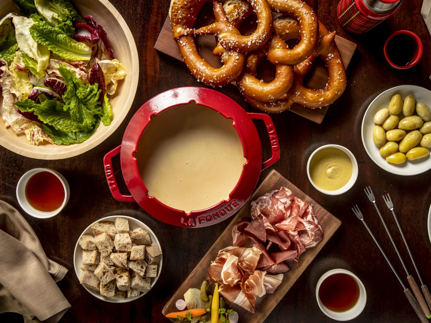 fondue with an assortment of foods to dip in it