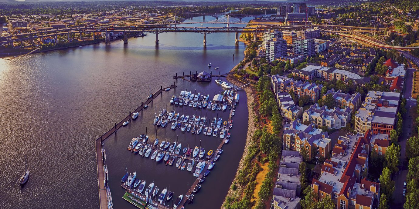 Aerial of Downtown Portland at Tom McCall Waterfront Park overlooking the Marina on early sunny morning with Tilikum Crossing Bridge in the distance