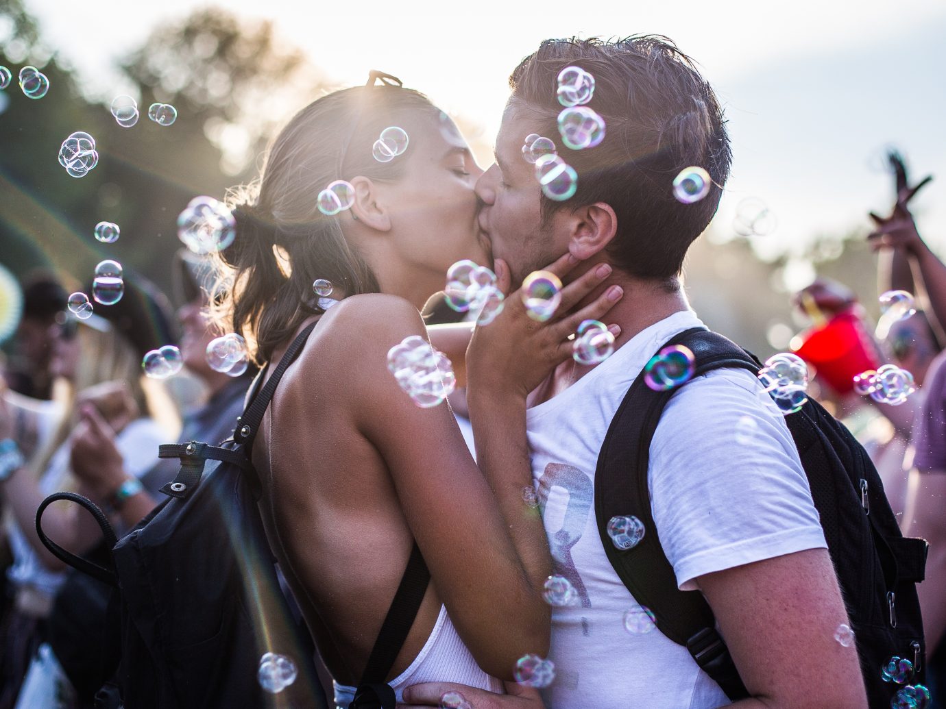 a couple kissing as bubbles fly by