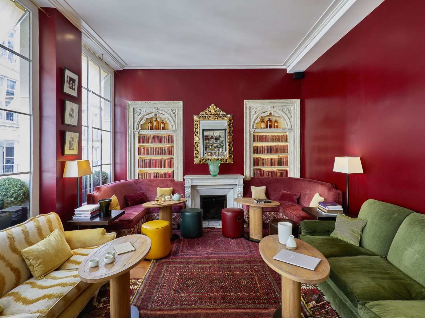 interior sitting space with red walls and carpet but with numerous colorful couches