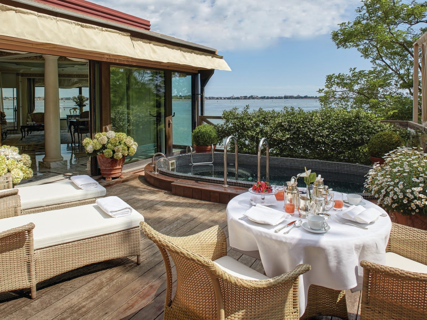 deck with chairs and a pool at Belmond Hotel Cipriani