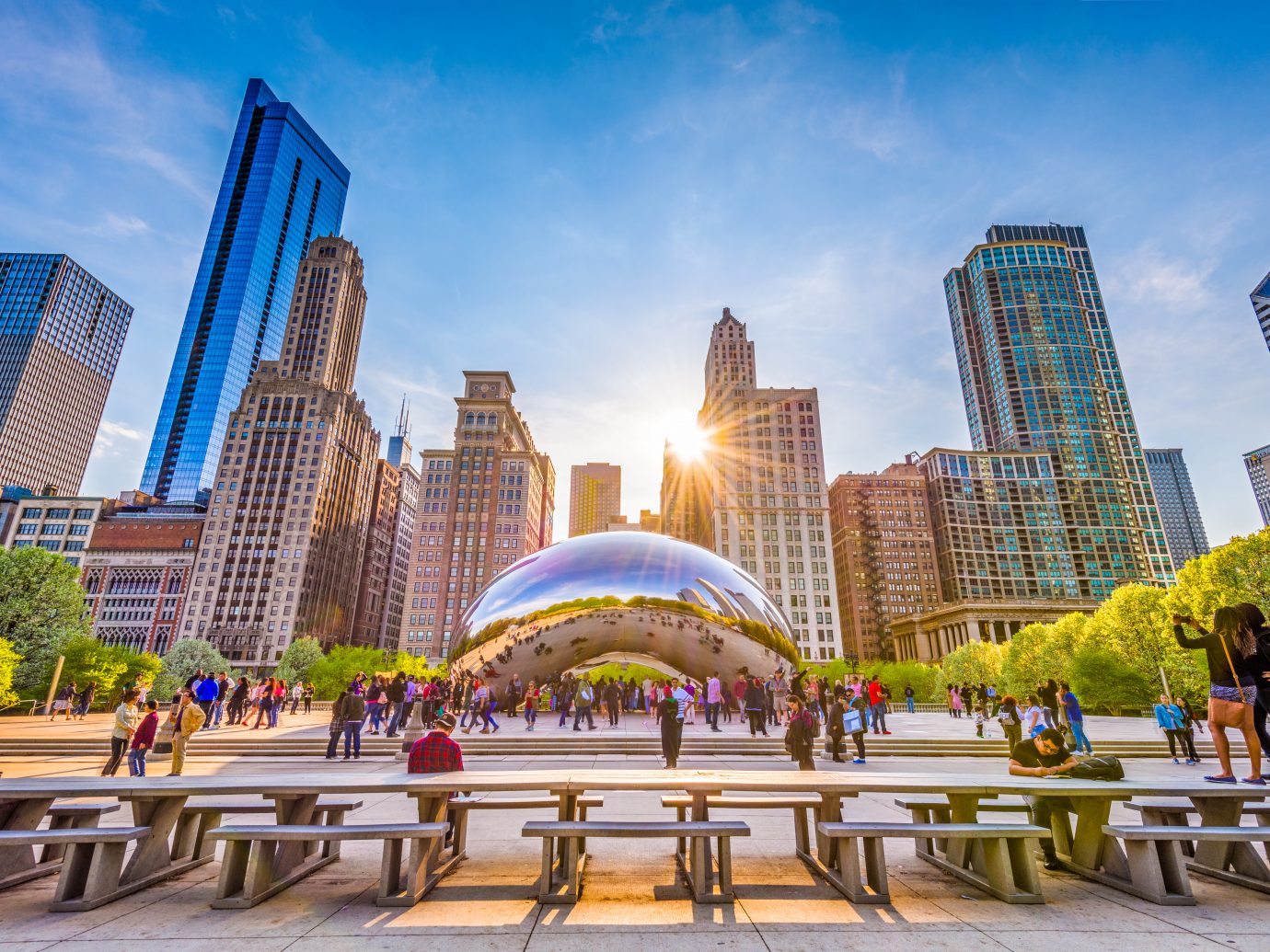 CHICAGO - ILLINOIS: MAY 9, 2018: Tourists visit Cloud Gate in Millennium Park in the late afternoon.