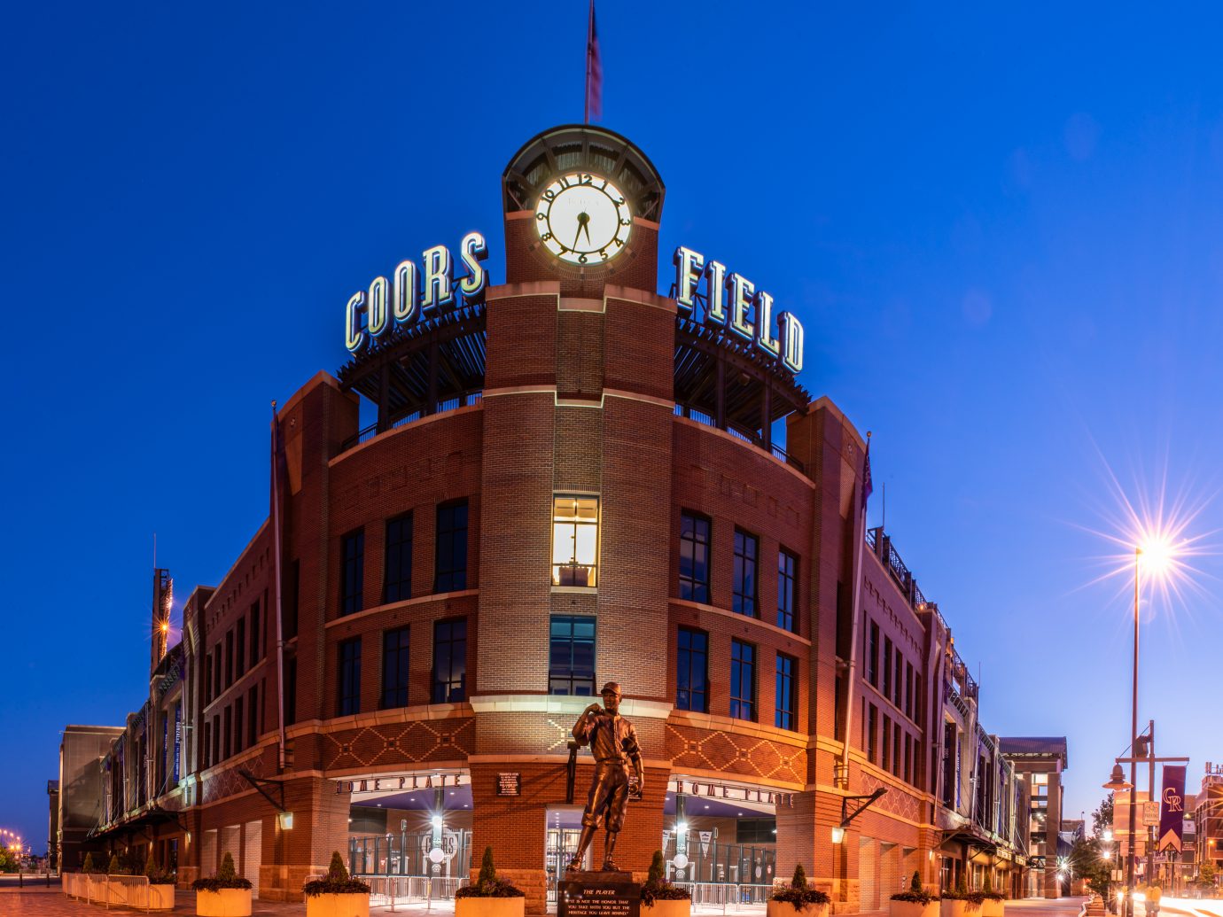 Coors Field, home of the Colorado Rockies baseball team, showing the glowing lights and vintage brick design in the early hours of a summer dawn on August 9, 2018 in Lodo, Denver.